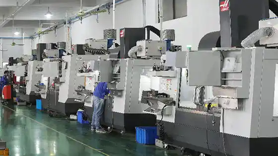 Side view of a production floor with a cup forming machine in operation