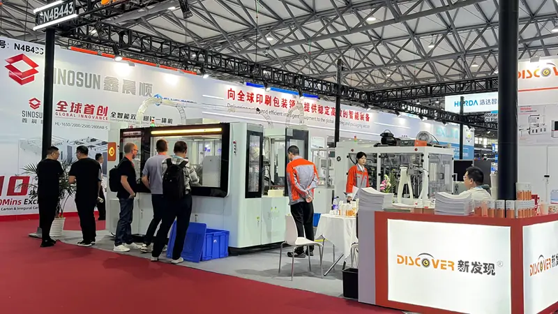 DISCOVER reception desk at booth N4B443, All in Print China 2026 Shanghai, team receiving buyers
